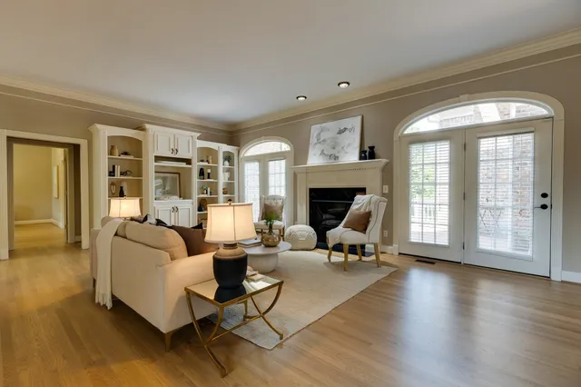 a kitchen with stainless steel appliances white cabinets and wooden floors