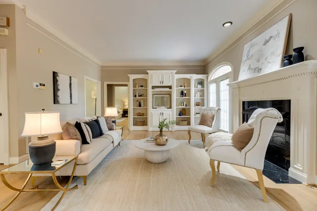 a kitchen with stainless steel appliances granite countertop a refrigerator a stove a sink and white cabinets