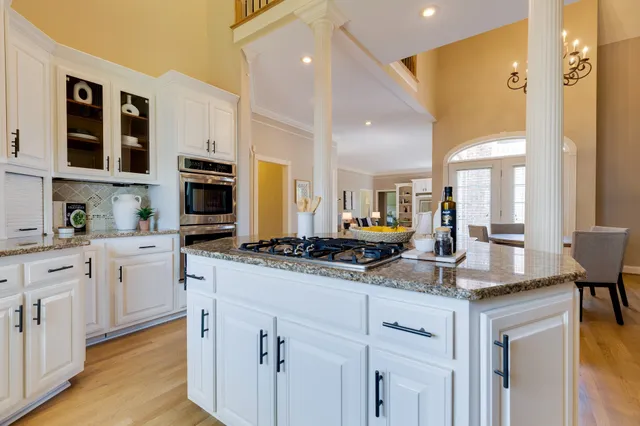 a kitchen with stainless steel appliances granite countertop a stove and a microwave oven