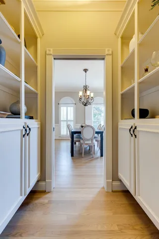 a view of staircase with railing and a clock