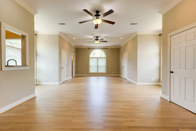 a spacious bathroom with a granite countertop sink a mirror and a shower
