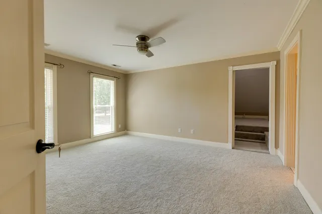 a view of an empty room with a ceiling fan
