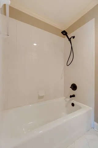a bathroom with a bathtub and a shower