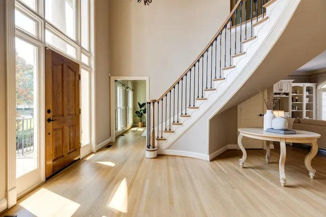 a living room with furniture a potted plant and a large window