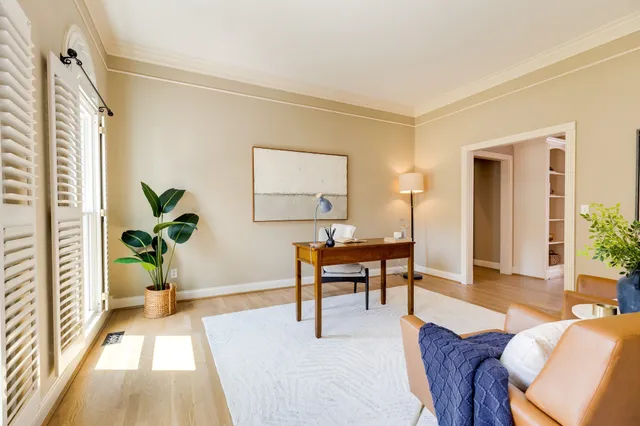 a living room with furniture and a chandelier