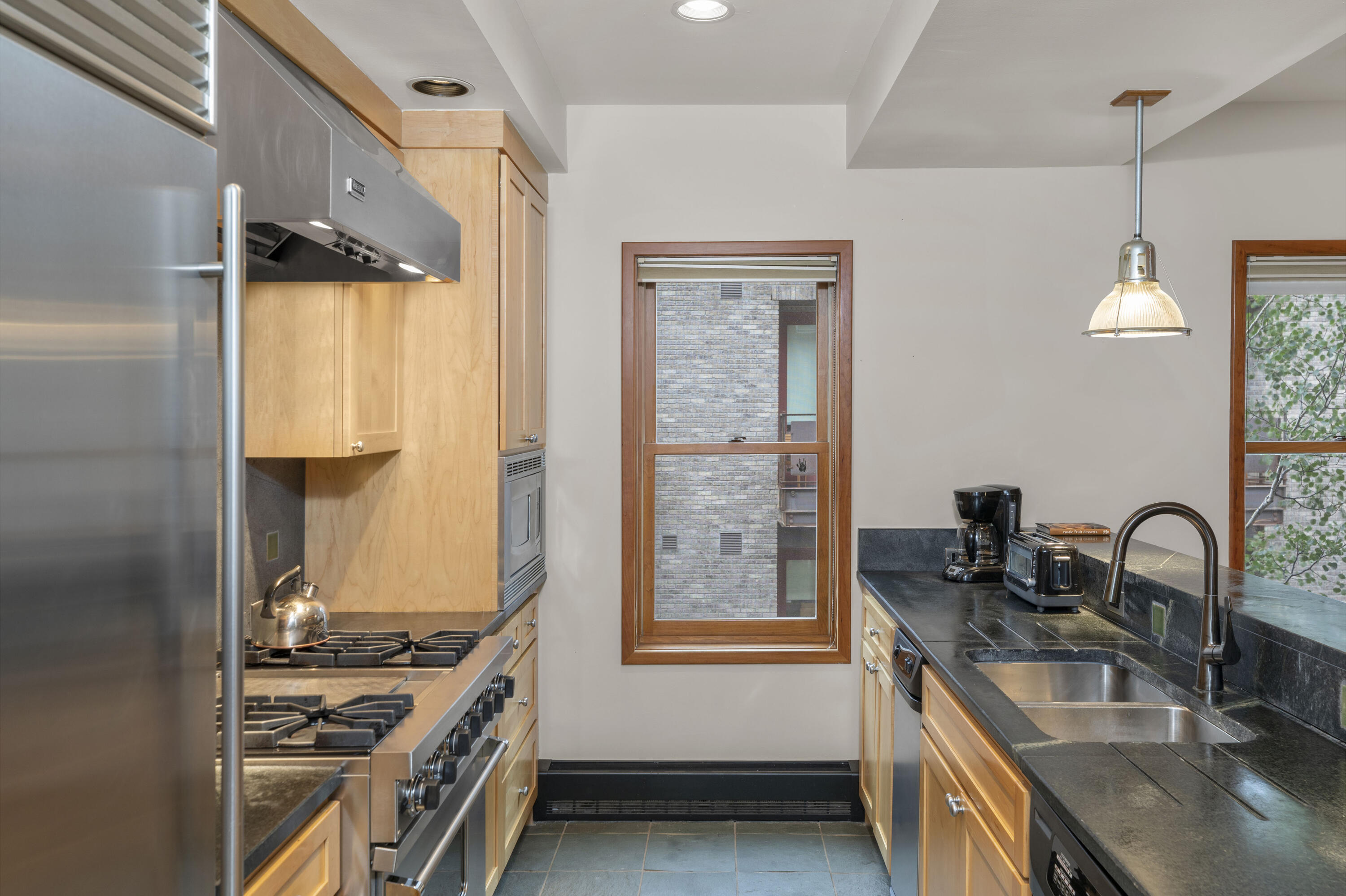 368 South Davis Street, Unit A7 Telluride, CO 81435 - Photo 4 of 14 a kitchen with stainless steel appliances granite countertop a sink stove and refrigerator