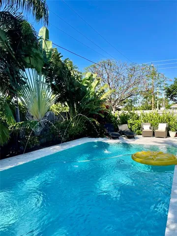 a view of a swimming pool with an outdoor space and seating area