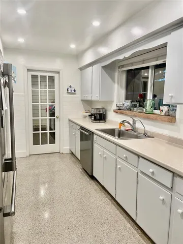 a kitchen with sink cabinets and window
