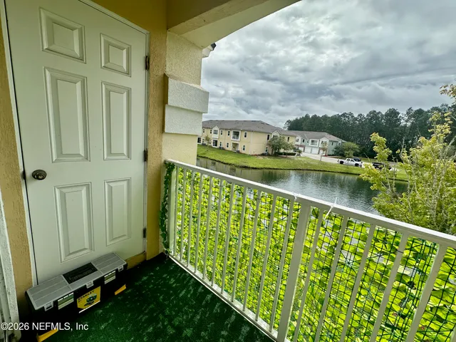 a view of a lake from a balcony with outdoor space