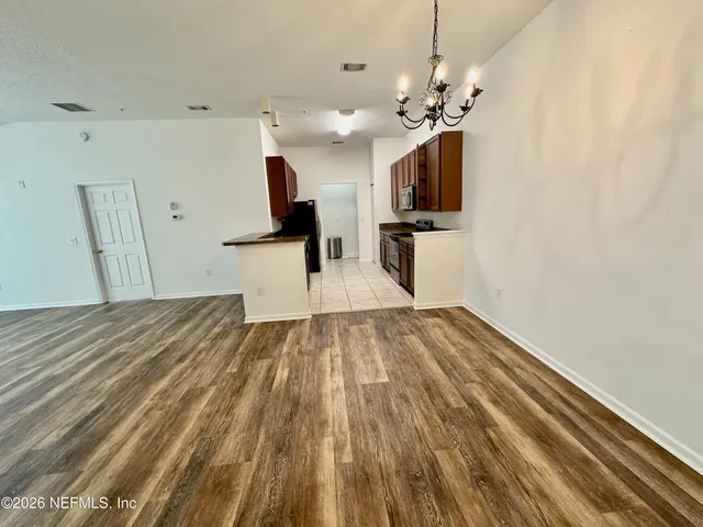 a view of a kitchen with a sink and a wooden floor