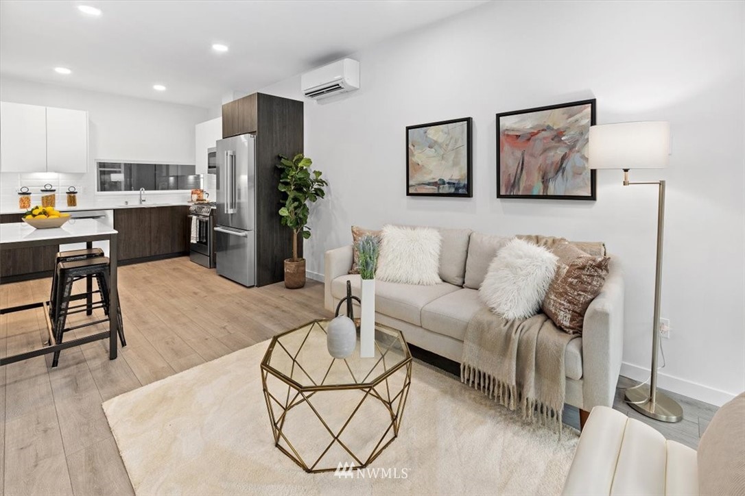 1271 North 145th Street Seattle, WA 98133 - Photo 14 of 32 a living room with furniture kitchen view and a wooden floor