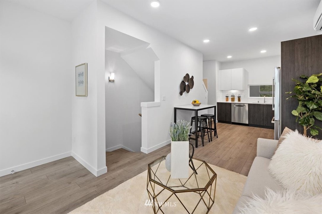 1271 North 145th Street Seattle, WA 98133 - Photo 17 of 32 a living room with furniture and kitchen view with wooden floor