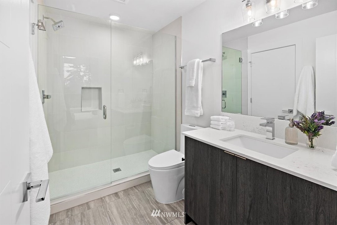 1271 North 145th Street Seattle, WA 98133 - Photo 23 of 32 a bathroom with a sink a toilet and shower