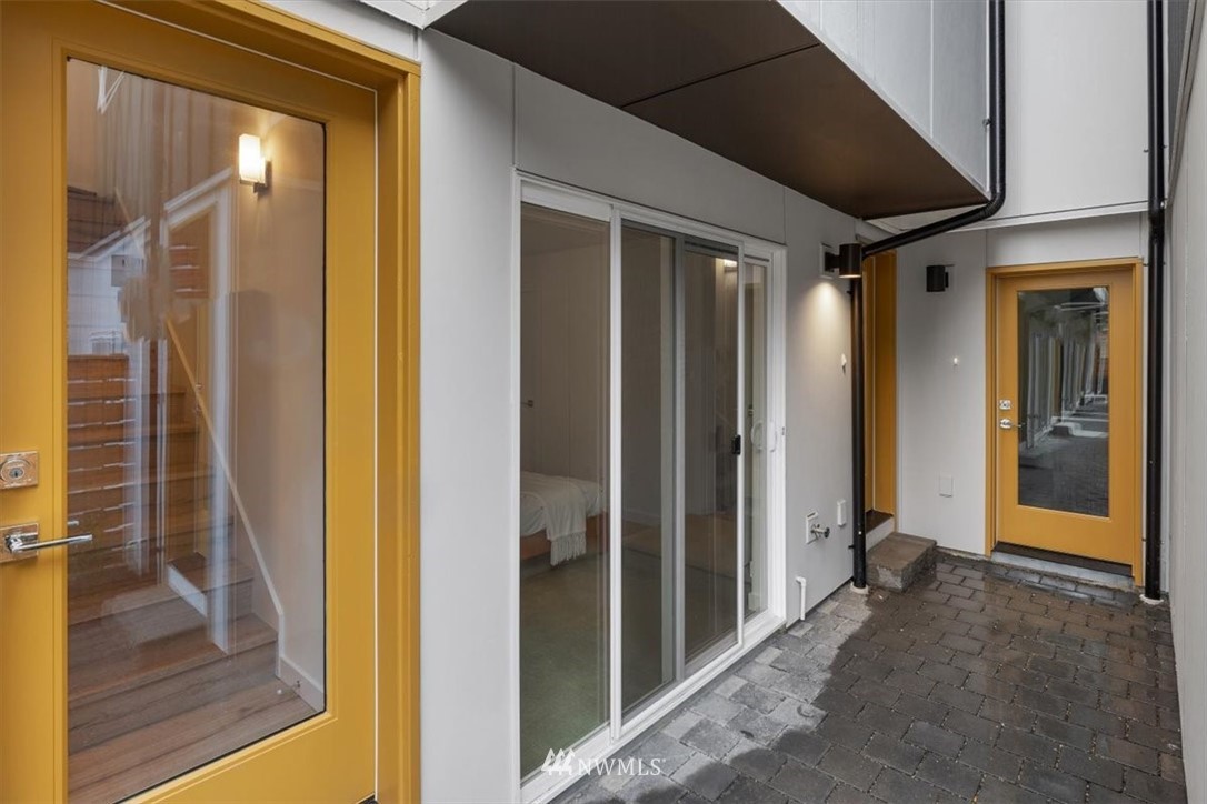 1271 North 145th Street Seattle, WA 98133 - Photo 4 of 32 a view of a hallway with wooden floor and staircase