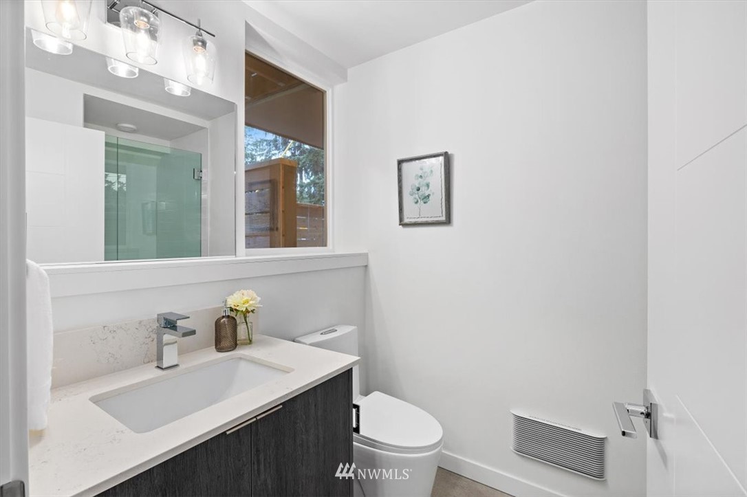 1271 North 145th Street Seattle, WA 98133 - Photo 9 of 32 a bathroom with a sink a toilet and mirror