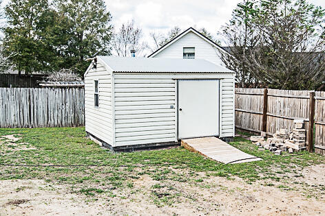 543 Tikell Drive Crestview, FL 32536 - Photo 23 of 27 a view of a house with a yard and wooden fence