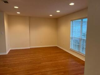 543 Tikell Drive Crestview, FL 32536 - Photo 4 of 27 an empty room with wooden floor and windows