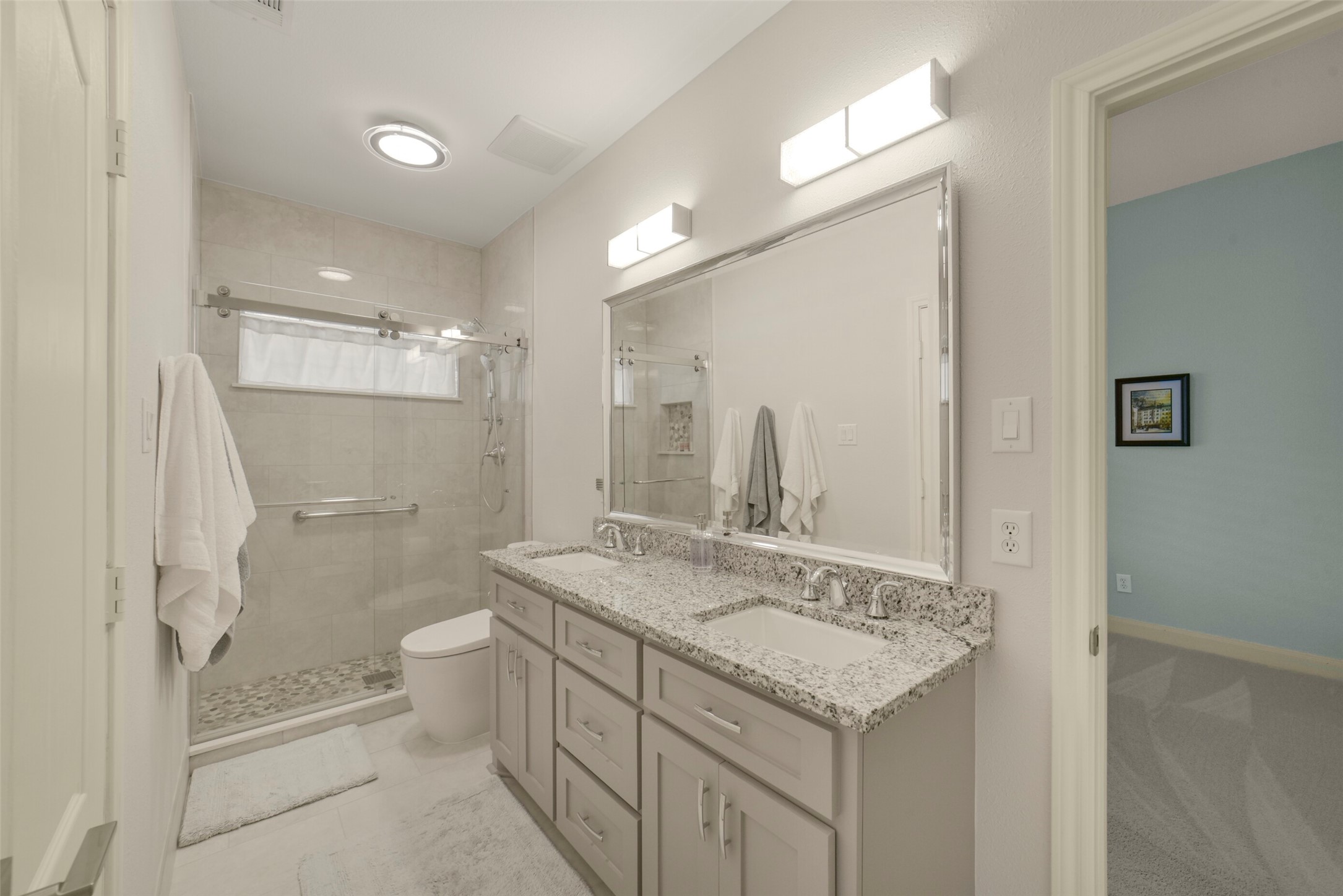 1310 Lambourne Circle Spring, TX 77379 - Photo 36 of 50 Secondary bathroom with new Kohler Archer double sinks, 3cm Valle Nevado granite countertops, tile base boards, Grohe Essence toilet