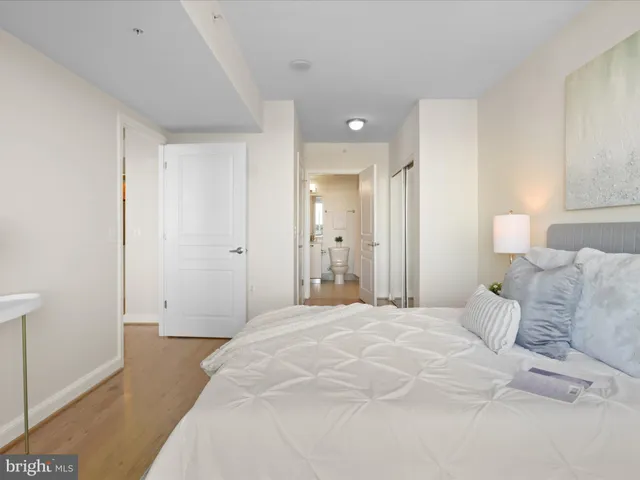 a bedroom with a bed and a potted plant