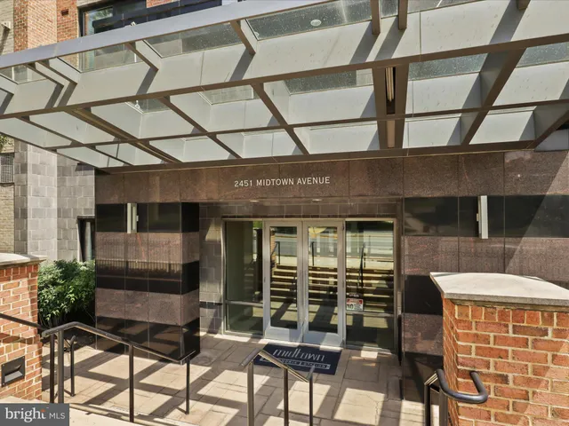 a lobby with furniture and floor to ceiling window