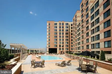 a front view of building with outdoor space and swimming pool