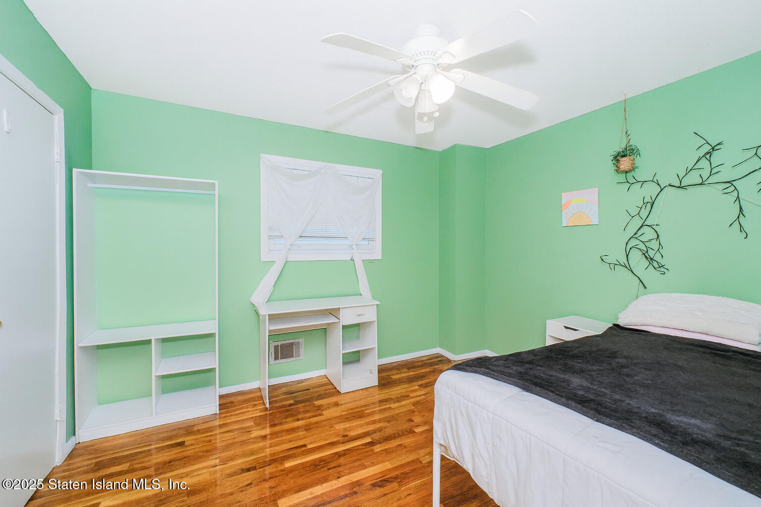 154 Merrill Avenue Staten Island, NY 10314 - Photo 16 of 21 a bedroom with a bed and a chandelier