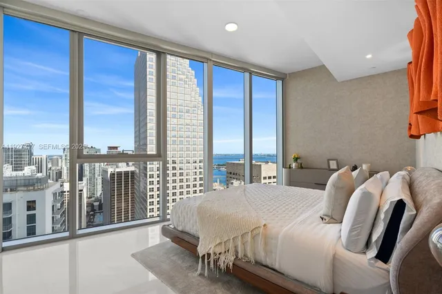 a bedroom with a large bed and a large window