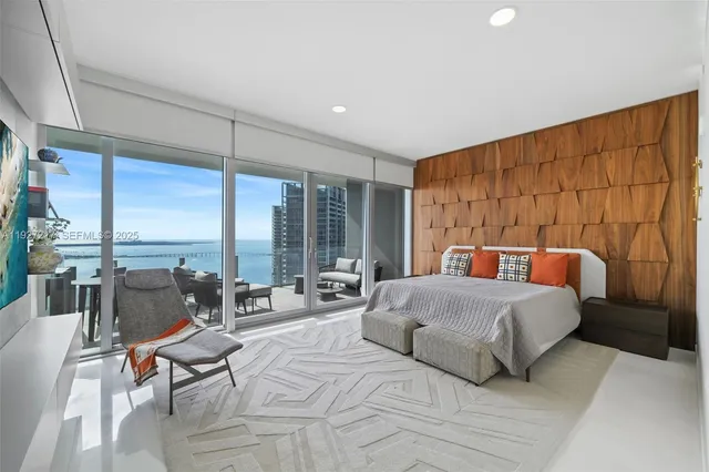 a spacious bedroom with a large bed and large windows