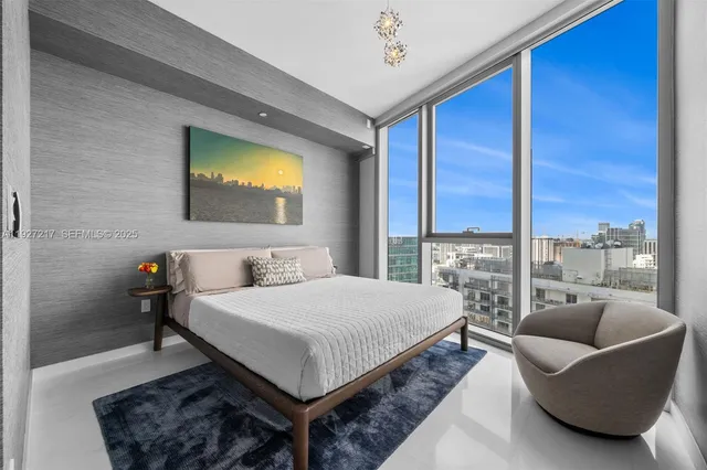 a bedroom with a bed and glass window