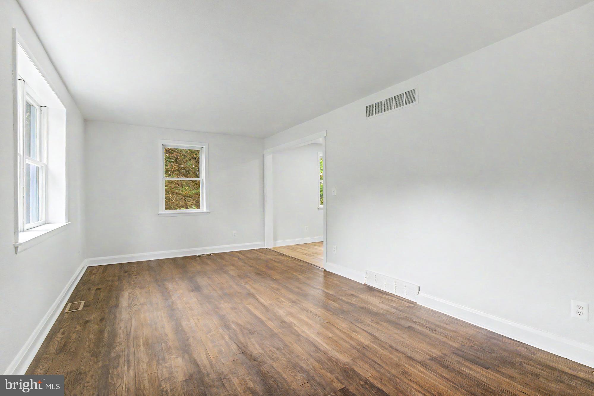 604 Prospect Mill Road Bel Air, MD 21015 - Photo 4 of 36 an empty room with wooden floor and windows