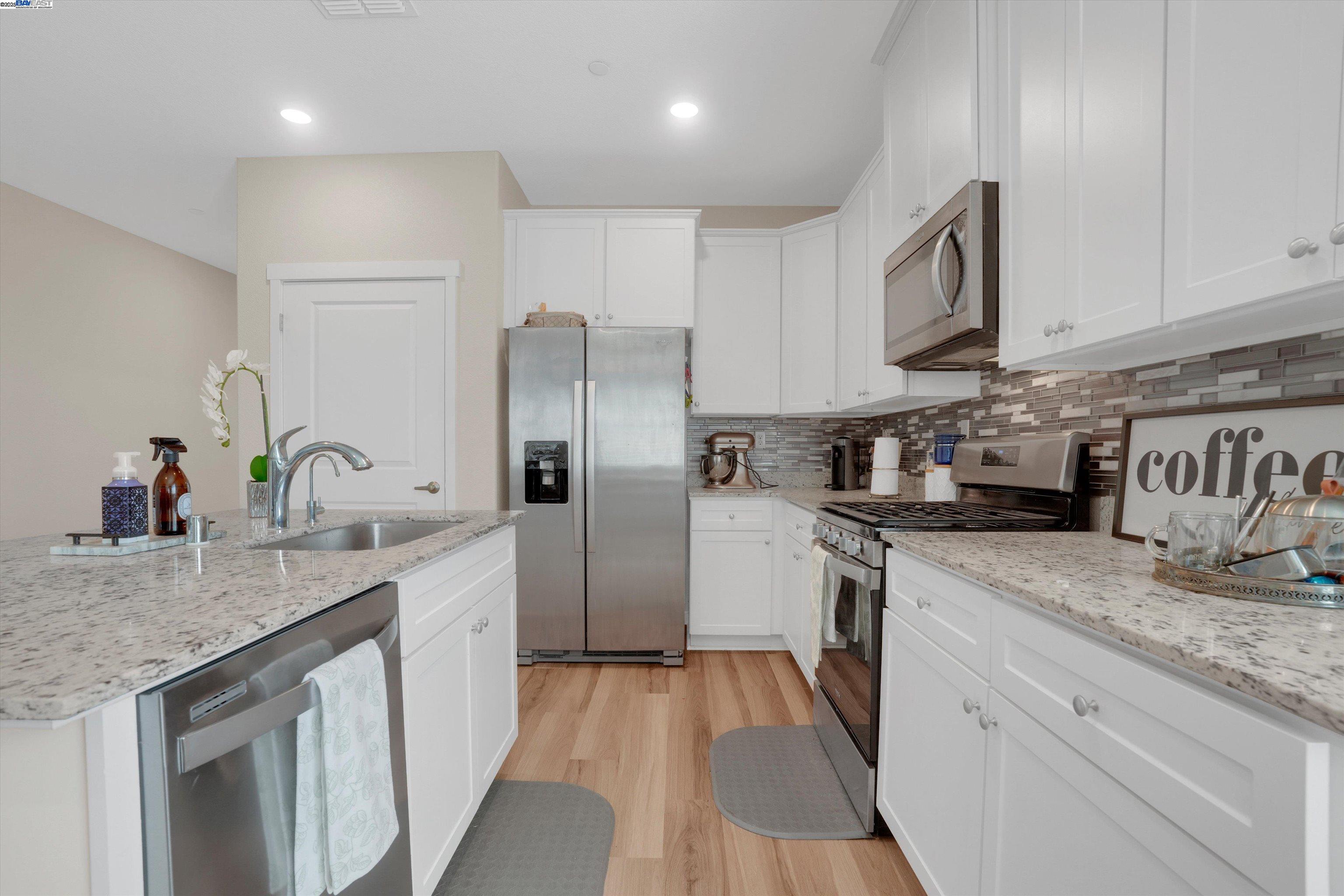 2211 Lavender Place Rio Vista, CA 94571 - Photo 14 of 36 a kitchen with granite countertop a sink stove and refrigerator