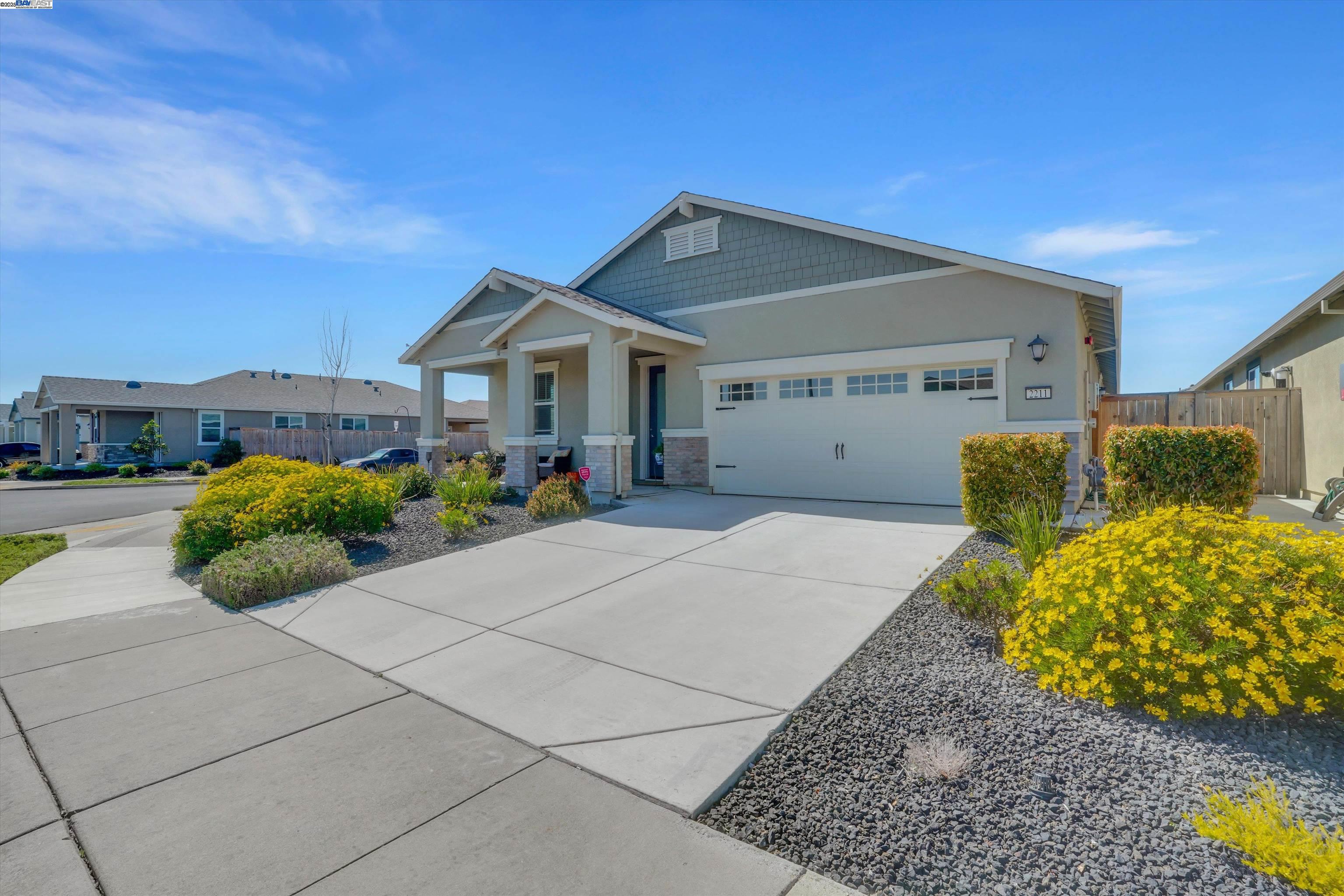 2211 Lavender Place Rio Vista, CA 94571 - Photo 4 of 36 a view of a house with a small yard and a large tree