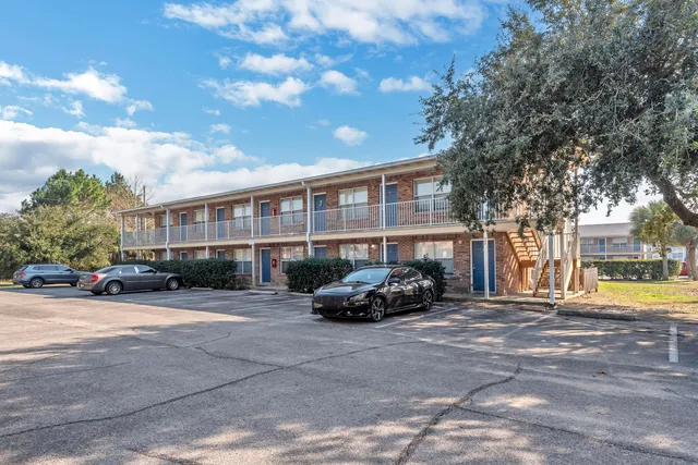 a car parked in front of a brick house