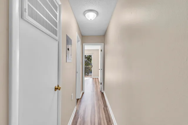 a view of a hallway with wooden floor