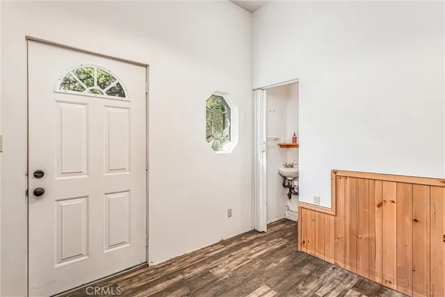 a view of an entryway with wooden floor