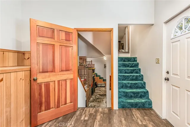 a view of a entryway with wooden floor and stairs