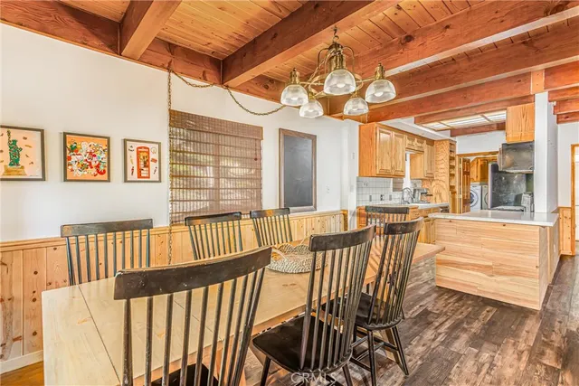 a view of a dining room and hall with wooden floor