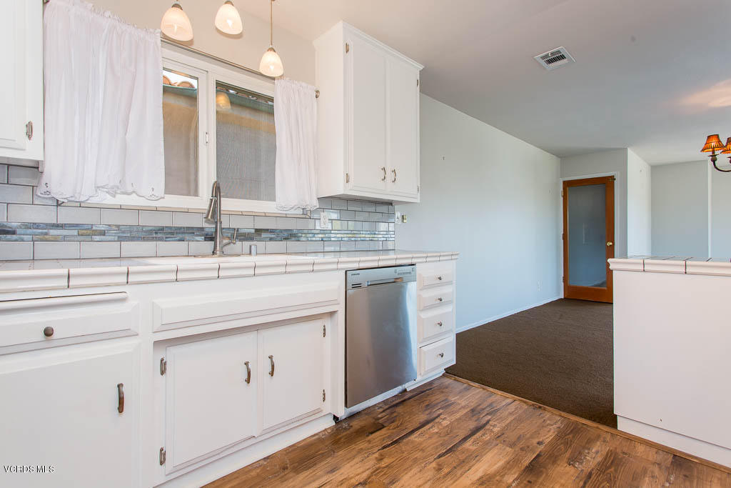 5051 Island View Street Oxnard, CA 93035 - Photo 15 of 38 a kitchen with a sink cabinets and a window