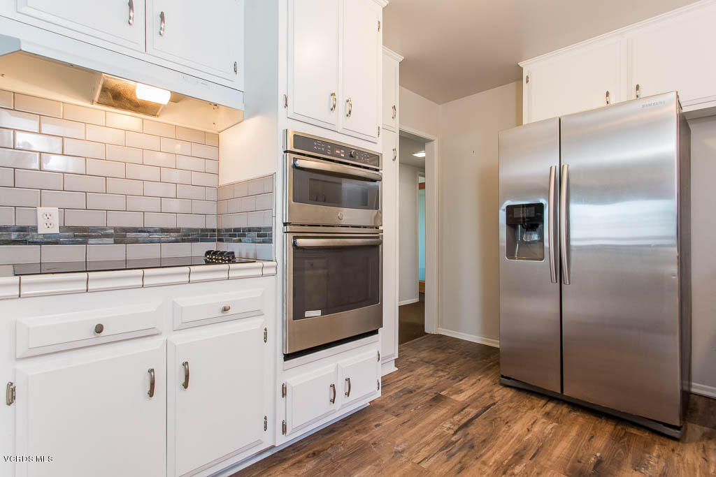 5051 Island View Street Oxnard, CA 93035 - Photo 16 of 38 a kitchen with stainless steel appliances a refrigerator sink and cabinets