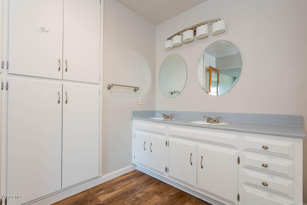 5051 Island View Street Oxnard, CA 93035 - Photo 24 of 38 a en suite bathroom with a granite countertop sink and mirror
