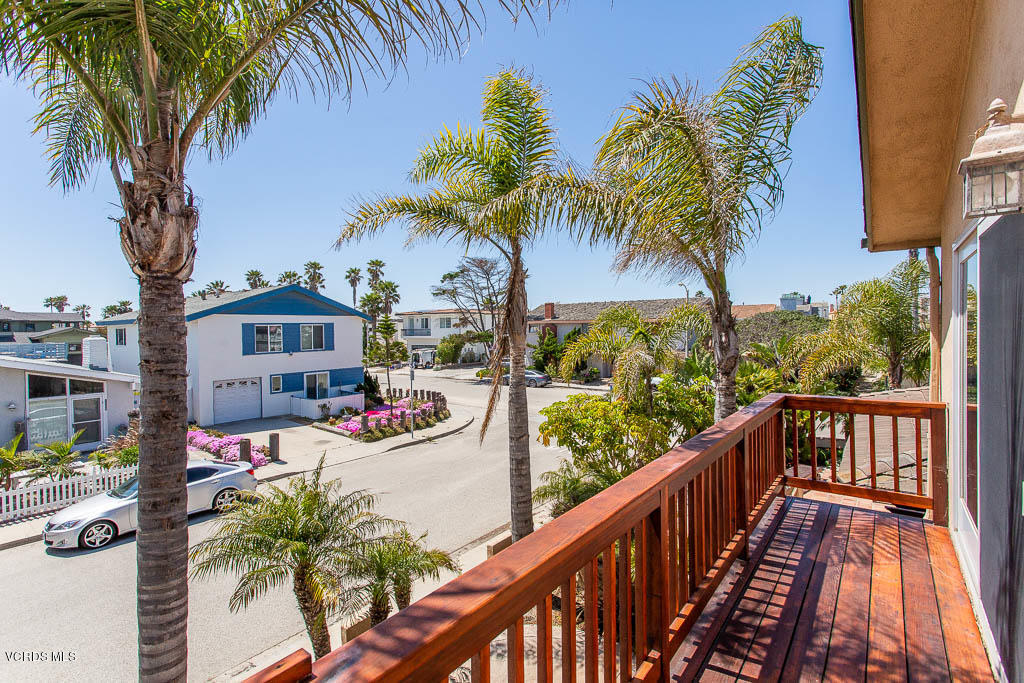 5051 Island View Street Oxnard, CA 93035 - Photo 6 of 38 a view of a balcony with potted plants and palm trees