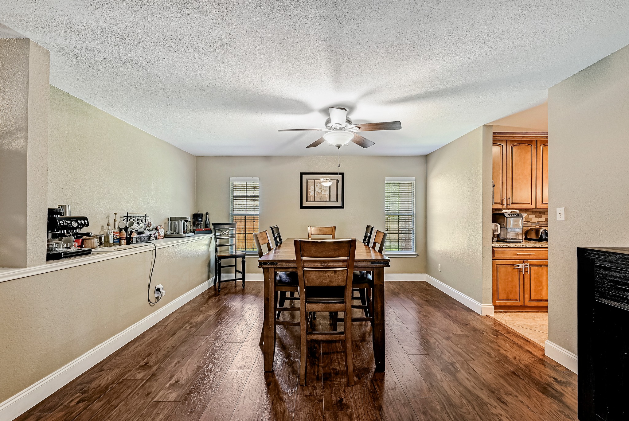 104 North Sumac Lane Georgetown, TX 78633 - Photo 22 of 40 Rich hardwood-style flooring extends through this open-concept dining area, perfect for entertaining.