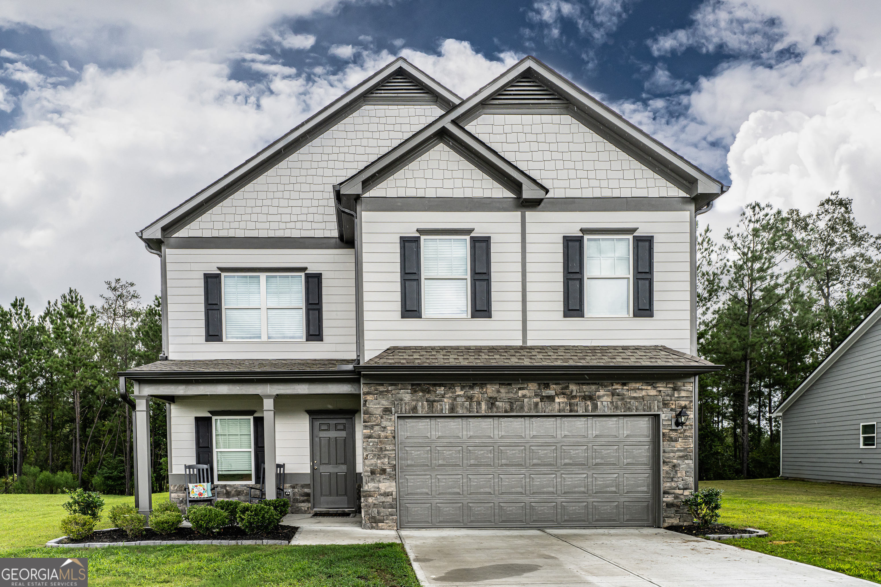 a front view of a house with garden