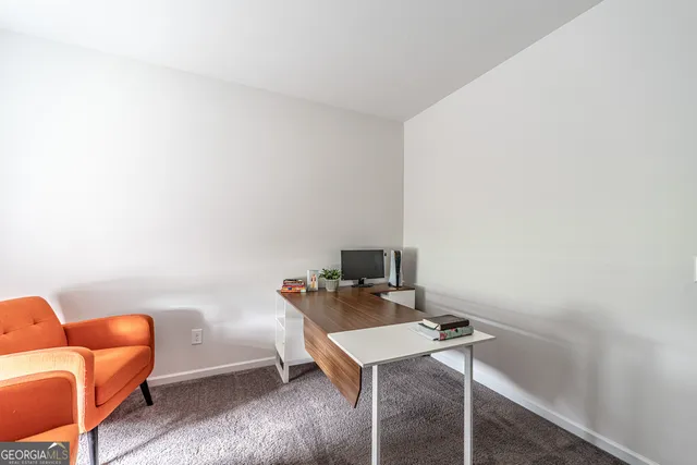 a view of a workspace with furniture