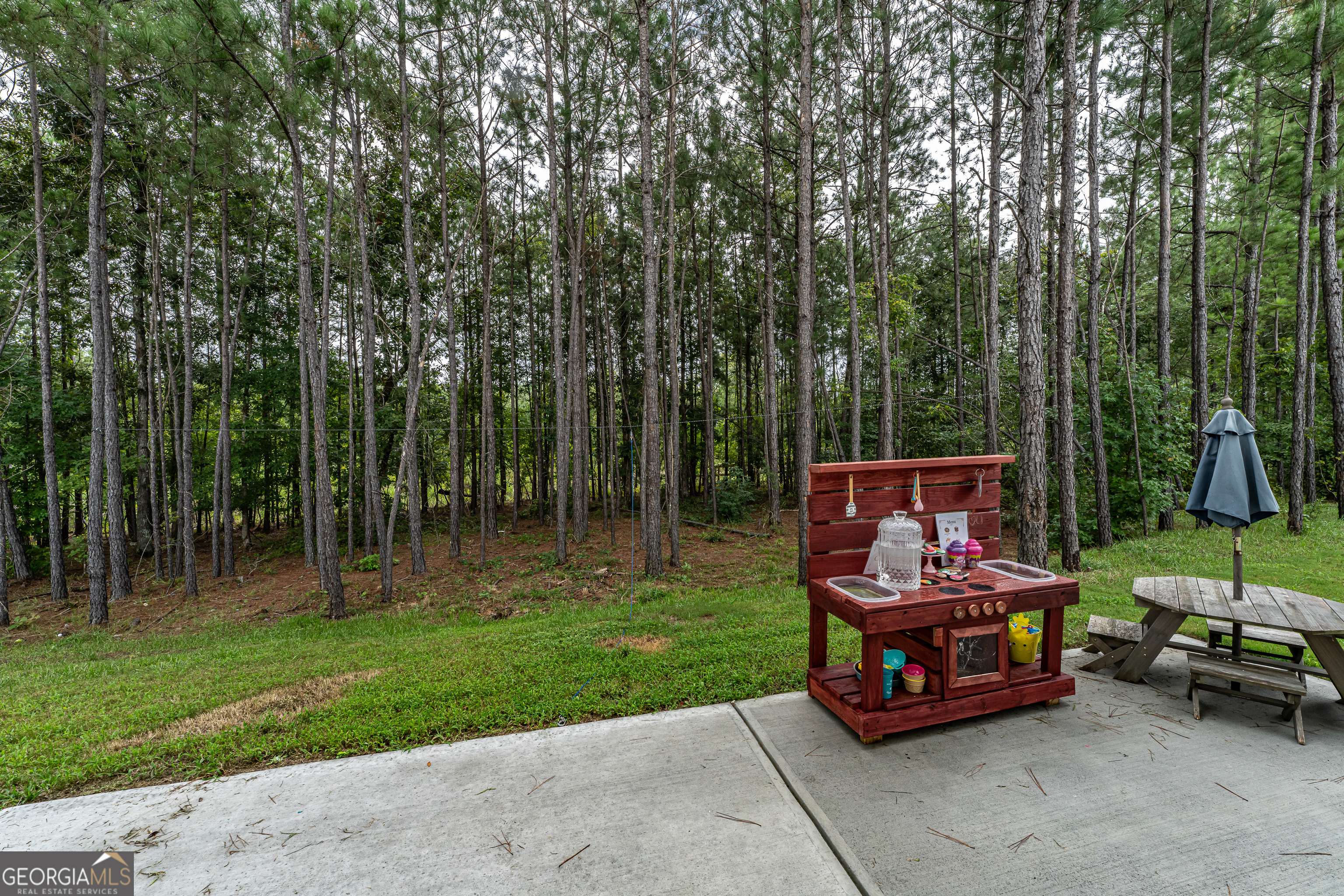 84 Royal Oak Drive Northeast Rome, GA 30165 - Photo 27 of 27 a sitting area with swimming pool and trees in the back