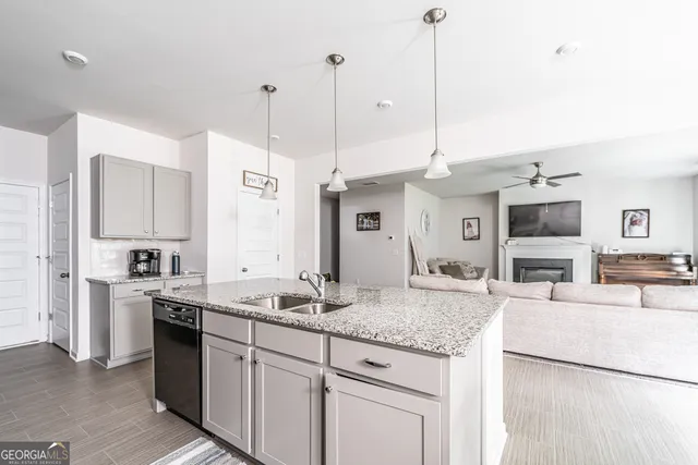 a kitchen with stainless steel appliances granite countertop a sink a stove and a refrigerator