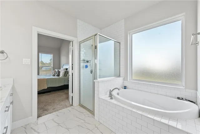 a spacious bathroom with a bathtub and a shower