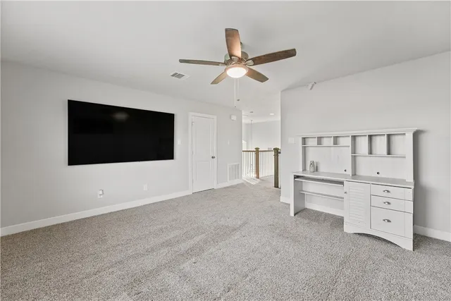 a view of a livingroom with furniture and a ceiling fan