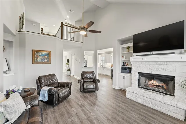 a living room with furniture a flat screen tv and a fireplace