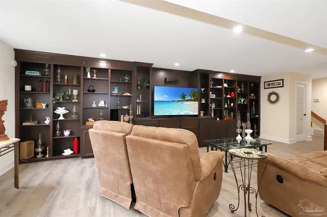 a living room with fireplace furniture and a dining table